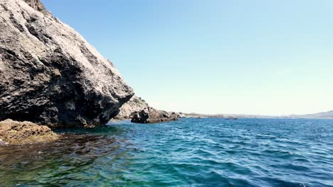 A-large-rock-formation-juts-out-into-the-Black-Sea-near-Sudak,-Crimea,-Russia