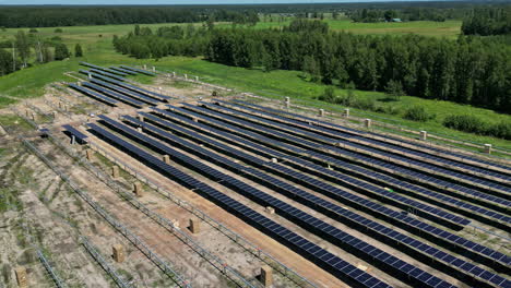 Aerial-time-lapse-installation-of-solar-panels,-green-energy-project-development