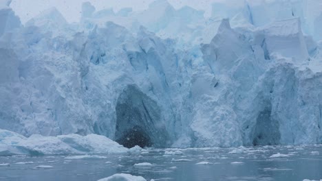 Ice-Caves-in-Massive-Glacier-on-Coast-of-Antarctica-on-Cold-Snowy-Day,-Slow-Motion