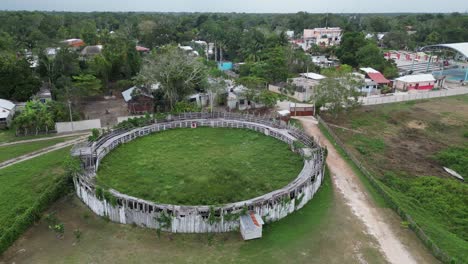 Aerial-orbits-long-neglected-circular-rodeo-paddock-in-Noh-Bec,-Mexico