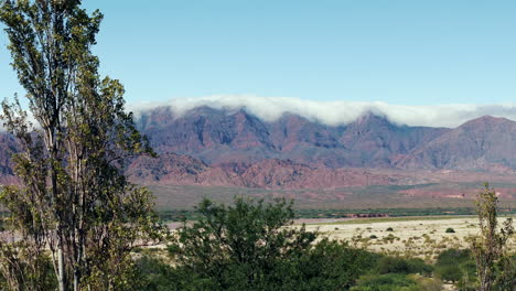 Beautiful-aerial-image-of-the-Cachalquie-Valley-and-the-Andes-Mountains-with-clouds-embracing-them