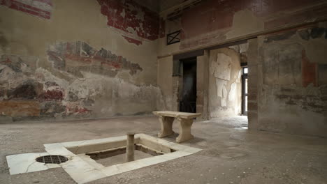 Ancient-Herculaneum-ruins-of-a-grand-villa-atrium-with-a-water-fountain-and-impluvium-to-catch-rain-water