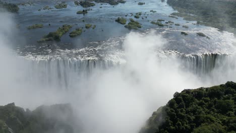 Aerial-Drone-View-of-Victoria-Falls-and-the-Rainbows,-In-Between-Zambia-and-Zimbabwe