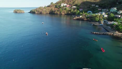 Revealing-Aerial-over-Buccament-Bay-at-Sunset,-Saint-Vincent