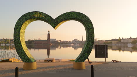 Sunrise-drone-view-of-City-Hall-across-Riddarfjärden-from-Söder-Mälarstrand