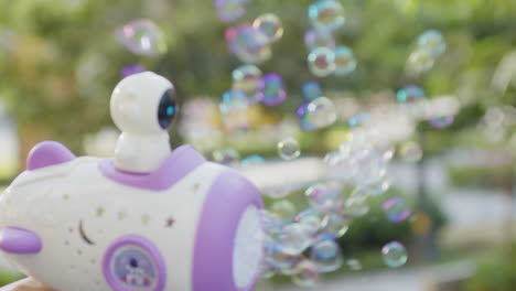 close-up-of-gun-toy-soap-bubble-maker-female-young-girl-holding-during-summer-holiday