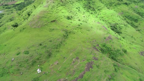 Temple-on-the-hill-with-fort-surrounding-in-Maharashtra-India,-aerial-travel-video-while-exploring-the-rural-area