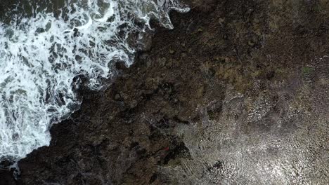 Ascending-Birds-Eye-Shot-of-Waves-at-Chidenguele-Beach-in-Mozambique