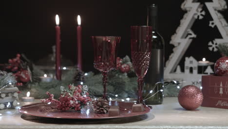 Man-steals-two-chocolates-from-a-decorated-Christmas-table-in-a-dark-room,-close-up-shot