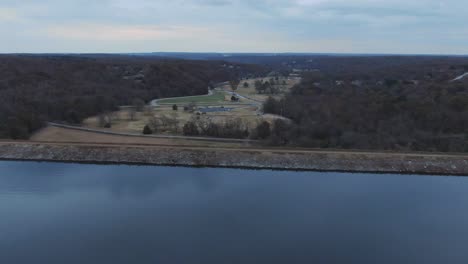 Aerial-view-past-the-lake-damn-toward-the-golf-across-the-road