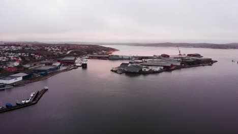 The-beautiful-and-misty-Lysekil,-Sweden-with-mountains-in-the-distance---Aerial-shot