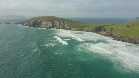 Aerial-view-of-Dunmore-Head,-it-is-a-promontory-in-the-westernmost-part-of-the-Dingle-Peninsula,-located-in-the-barony-of-Corca-Dhuibhne-in-southwest-County-Kerry,-Ireland