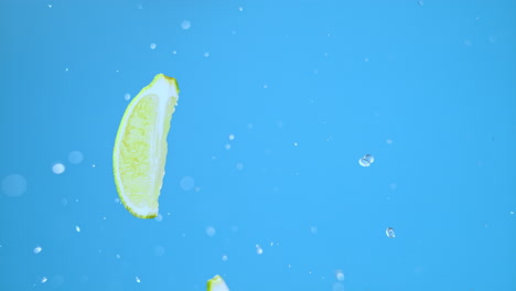 Lime-slices-jumping-in-air-with-water-droplets