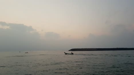 4k-Tracking-Shot-of-a-Fisherman-Boat-going-towards-the-sea-near-the-Old-Harbor,-Pondicherry,-India