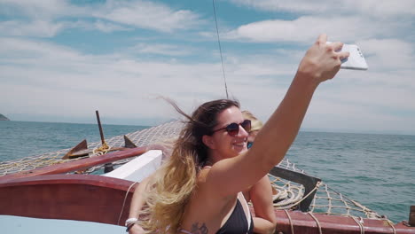 Model-having-a-selfie-during-boat-trip-in-Buzios---Rio-De-Janeiro---Brazil