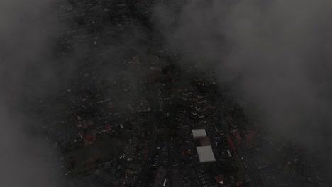 Bird's-eye-aerial-drone-shot-over-the-clouds-of-a-city-in-England,-Thteford