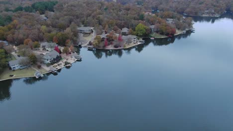 Aerial-view-of-twin-lake-shore-homes-with-fall-colors-on-display