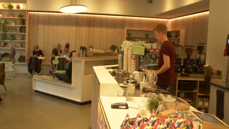 barista-prepares-coffee-at-trendy-cafe