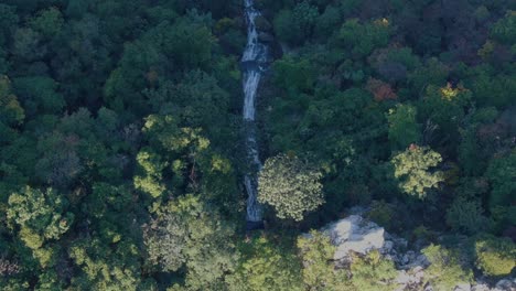 a-thin-flowing-waterfall-in-the-mountains-overlooking-from-above