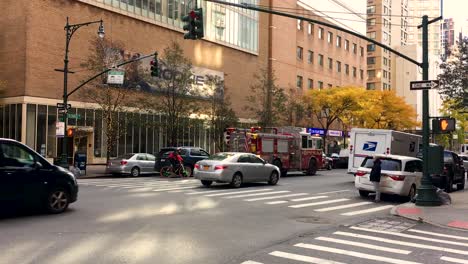 Fire-truck-driving-down-New-York-city-street-with-sirens