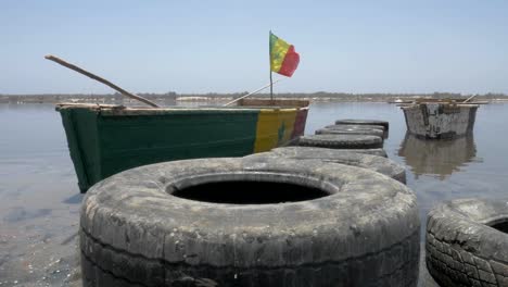 Cinematic-shoot-of-a-boat-in-pink-lake-of-senegal-with-smooth-crane-stabilization