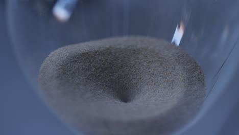 Hourglass-sand-falling-in-slow-motion-close-up-from-above