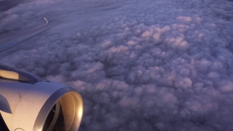 Looking-out-of-an-airplane-window-at-the-engine-as-the-flight-banks-left-to-descend-with-the-shadow-moving-across-the-engine-mouth-above-the-clouds-over-Paris