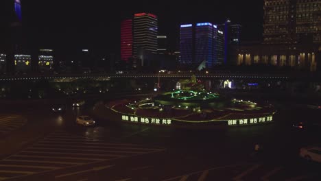 Roundabout-in-Shanghai,-China-at-night-with-busy-street-and-neon-light