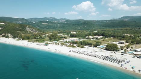 Karavostasi-Greece-beautiful-sunny-day-over-water-flying-down,-establishing-shot