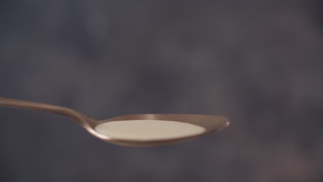 Liquor-splashing-on-spoon-in-slow-motion