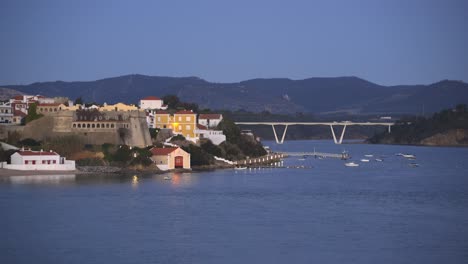 View-of-Vila-Nova-de-Milfontes-with-river-Mira-at-night,-in-Portugal