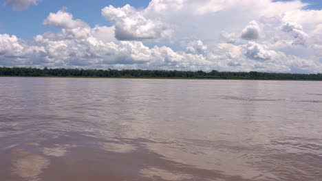 Sailing-with-wooden-vessel-down-Amazon-river-with-scenic-panorama-on-rainforest