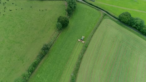 Top-down-aerial-of-a-tractor-cutting-a-grass-field