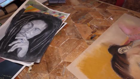 Colour-chalk-and-charcoal-drawings-and-paintings-slide-detail-on-a-table