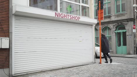 A-closed-Night-shop-with-people-passing-in-front