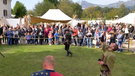 Wide-shot-showing-two-warrrior-fighting-with-fire-swords-at-Medieval-event