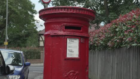 A-centre-aligned-close-up-shot-of-a-Red-Royal-Mail-Post-box-on-a-residential-street-in-South-West-London