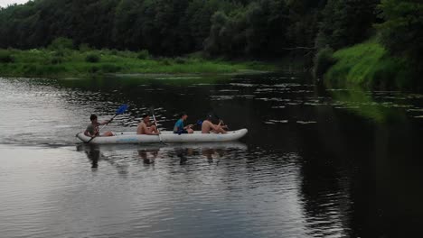 Aerial-View-of-Four-People-in-Canoe-Paddling-Down-River