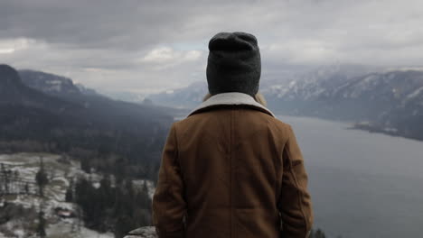 A-girl-gazes-out-at-a-gorge-from-a-scenic-viewpoint