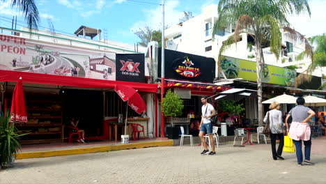 Two-Young-Men-Doing-Flips-And-Breakdancing-Tricks-On-The-Boardwalk-In-Mexico-In-Front-Of-Shops