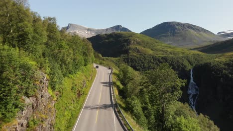 A-road-filmed-from-above-with-a-drone-in-front-of-the-Geirangerfjord-in-Norway