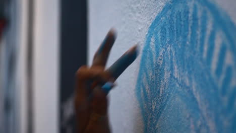 Close-up-of-a-black-woman's-hand-as-they-draw-the-statue-of-liberty-on-a-wall-during-a-chalk-the-block-black-lives-matter-rally