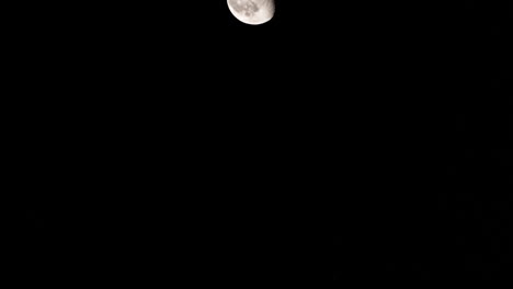 Moon-moving-through-the-clear-sky-with-no-clouds-telephoto-telescope-zoom