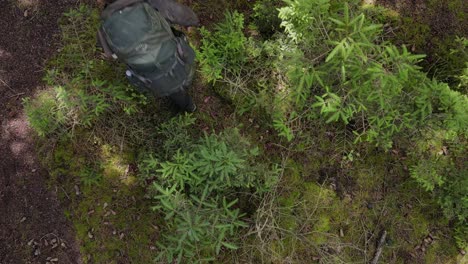 Two-guys-hiking-through-inland-terrain,-Drone-shot