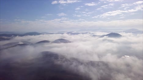 Serene-aerial-of-mist-and-clouds-over-mountains-near-Três-Rios,-Rio-de-Janeiro