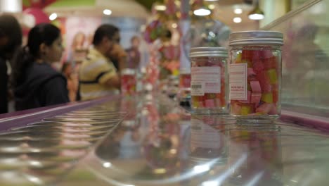 Sugary-candylicious-boxes-on-a-automatic-counter,-closeup