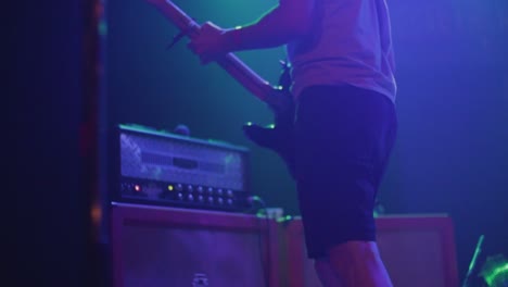 Guitar-player-adjusting-amp-before-concert