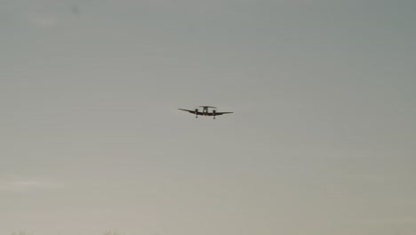 A-large-King-Air-propellor-airplane-makes-a-low-flyover-at-sunset