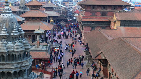 Aerial-View-of-People-strolling-around-the-ancient-palace-of-Patan-Durbar-Square-in-Kathmandu-surrounded-by-ancient-temples