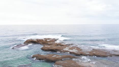 Drone-shot-over-a-rocky-seashore-area